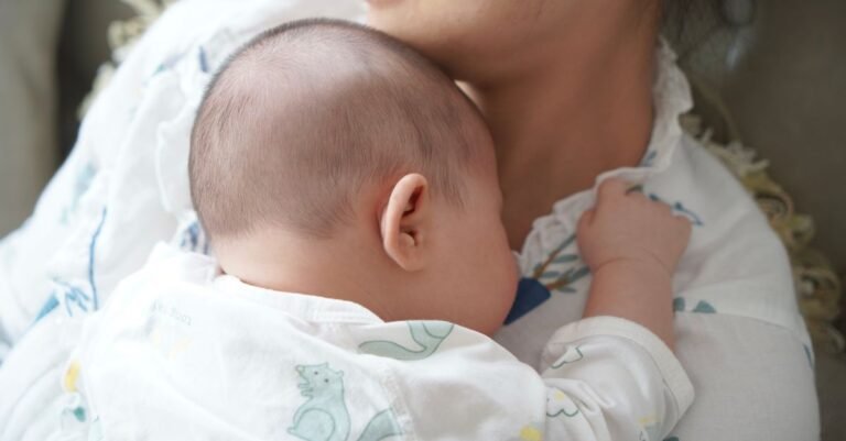 A newborn baby peacefully sleeps on the mother's chest, capturing a tender moment of love and comfort.