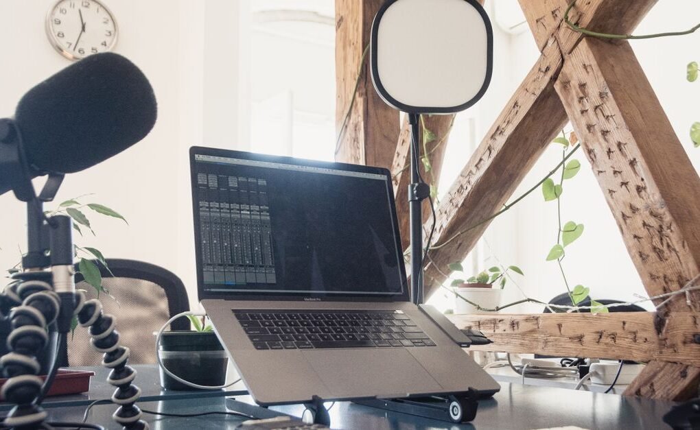 Modern podcast and digital creator setup with microphone and laptop - digital creator workspace